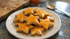 Stelline alle mandorle e cannella con glassa all’arancia: biscotti di Natale facili e profumati